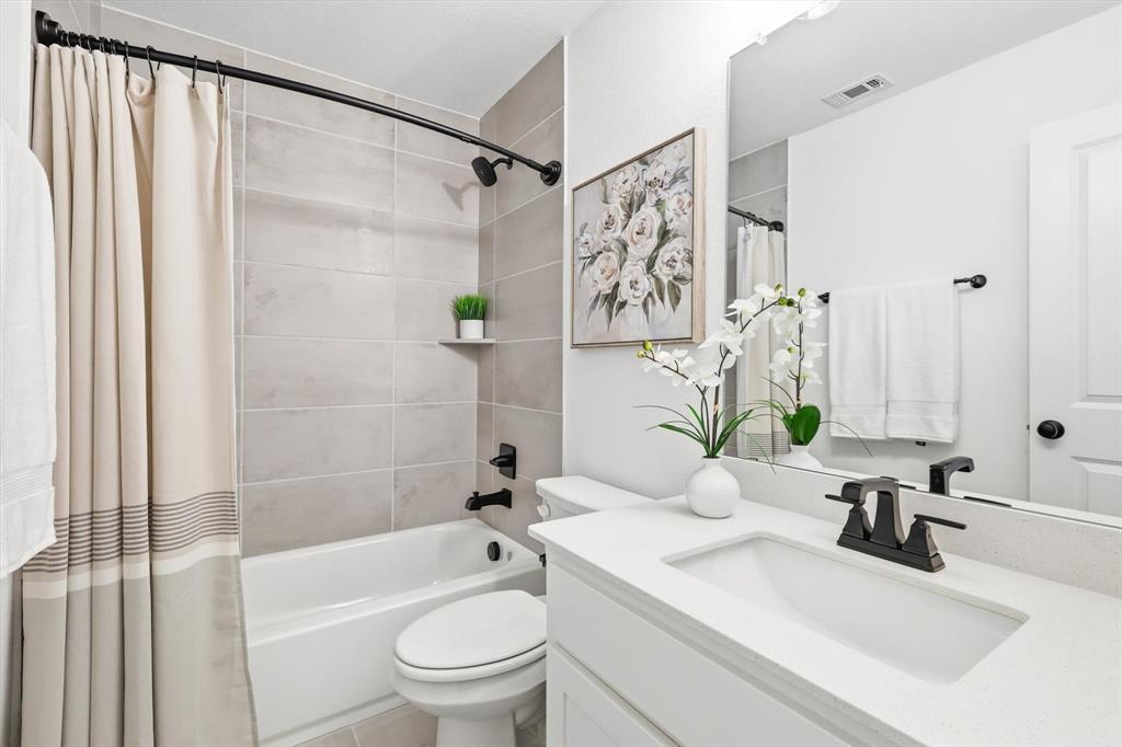 2171 Cloverfern Way Haslet, TX 76052 - Photo 24 of 38 a bathroom with a granite countertop sink a toilet and shower