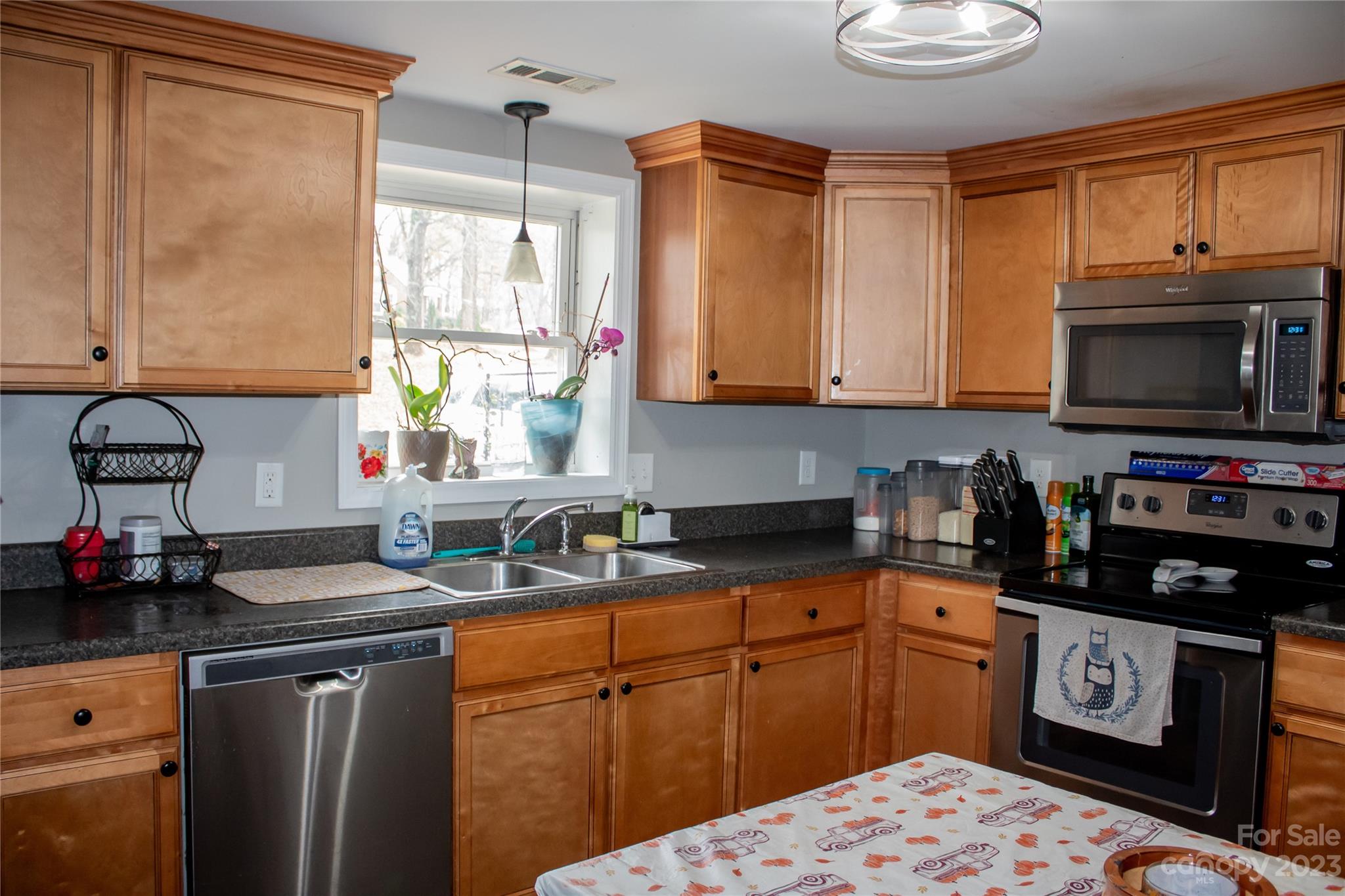 644 St James Church Road Newton, NC 28658 - Photo 7 of 11 a kitchen with stainless steel appliances granite countertop a sink stove and cabinets