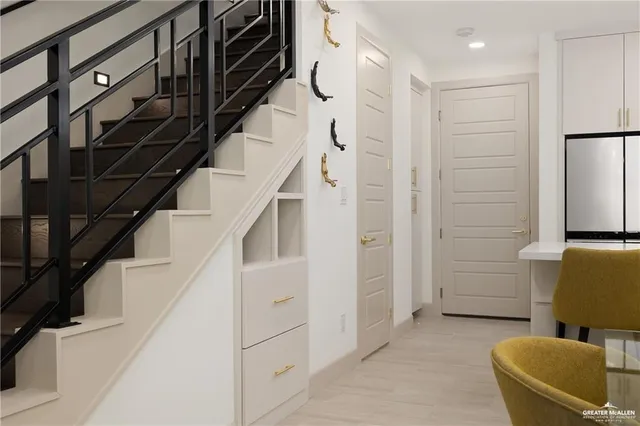 a view of hallway with furniture and stairs