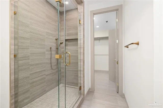 a bathroom with a shower and a sink