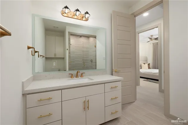 a en suite bathroom with a sink a toilet and a mirror