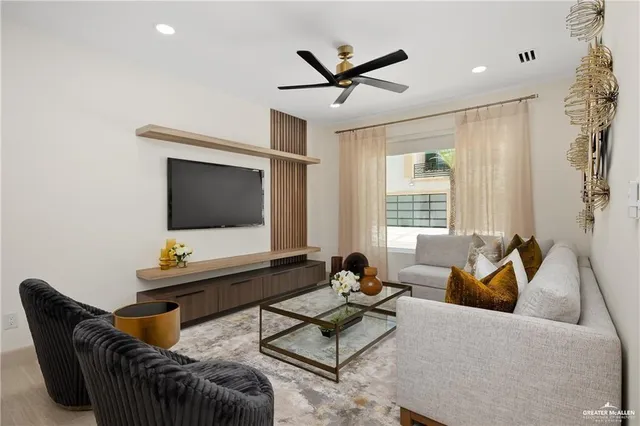 a living room with furniture and a flat screen tv