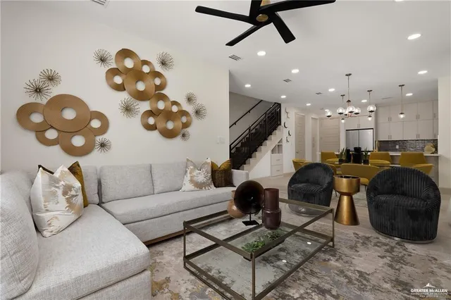 a living room with furniture and a chandelier
