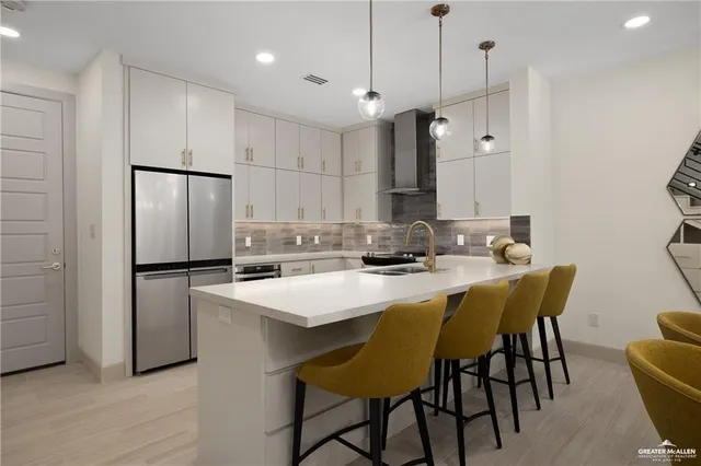 a kitchen with a table chairs and a refrigerator