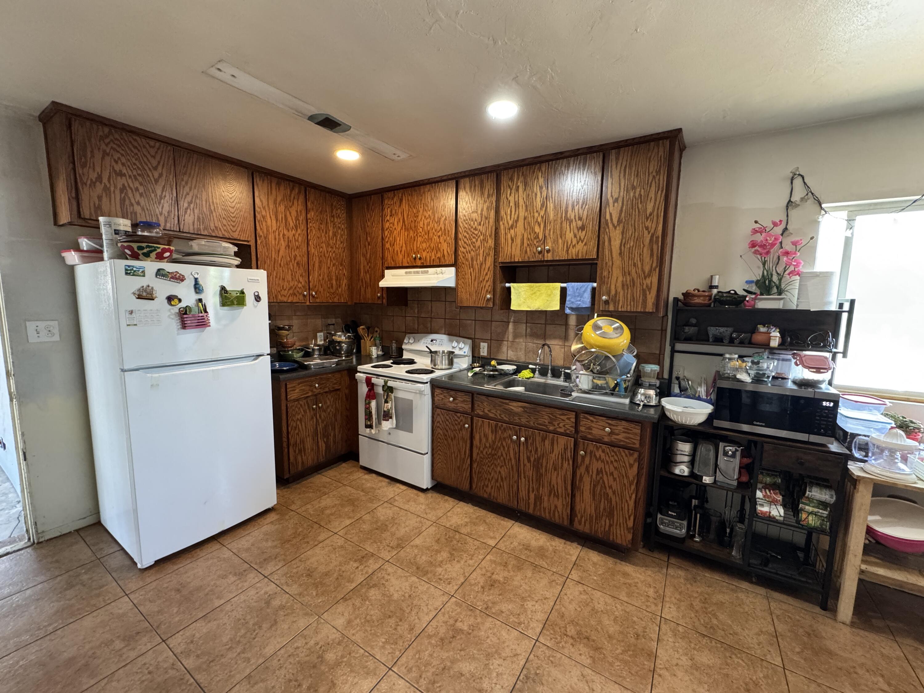704 North Floral Street Visalia, CA 93291 - Photo 13 of 51 a kitchen with stainless steel appliances granite countertop a refrigerator stove top oven and sink