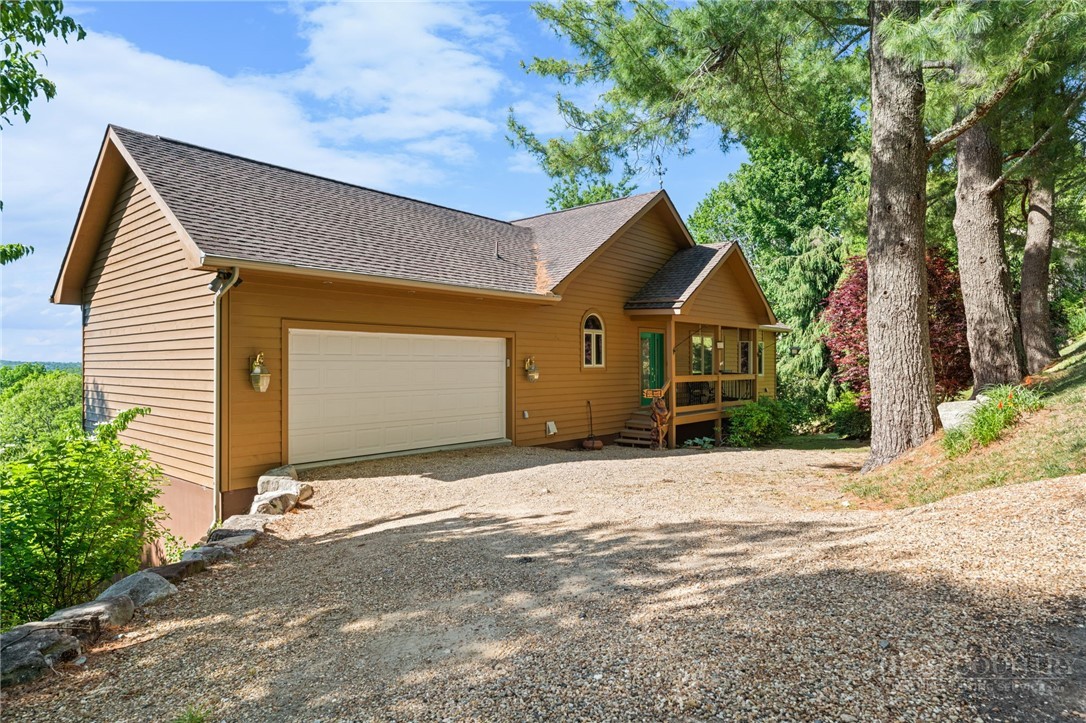 331 Alpine Road Blowing Rock, NC 28605 - Photo 3 of 50 a front view of a house with a yard and garage