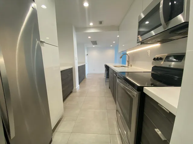 a kitchen with a sink and refrigerator