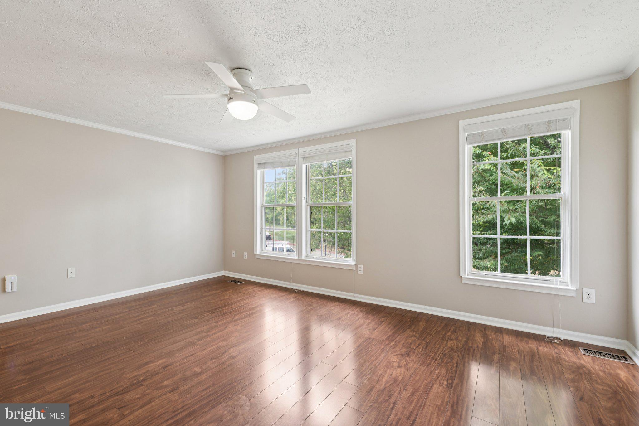 7813 Paddock Way Windsor Mill, MD 21244 - Photo 12 of 30 a view of an empty room with wooden floor and a window