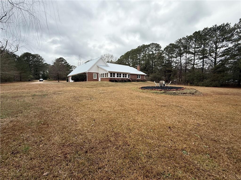 3280 Stanton Road Southeast Conyers, GA 30094 - Photo 13 of 49 a view of a house with a yard and mountain view in back