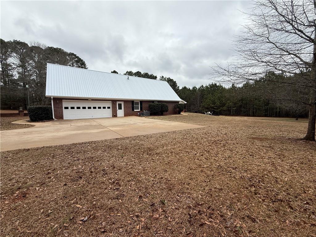 3280 Stanton Road Southeast Conyers, GA 30094 - Photo 14 of 49 a view of a big house with a big yard and large trees