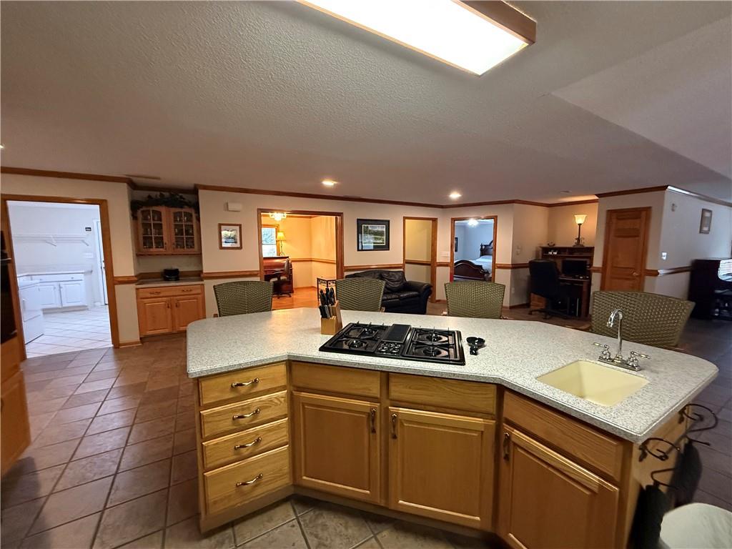 3280 Stanton Road Southeast Conyers, GA 30094 - Photo 19 of 49 a kitchen with kitchen island granite countertop a sink cabinets and wooden floor