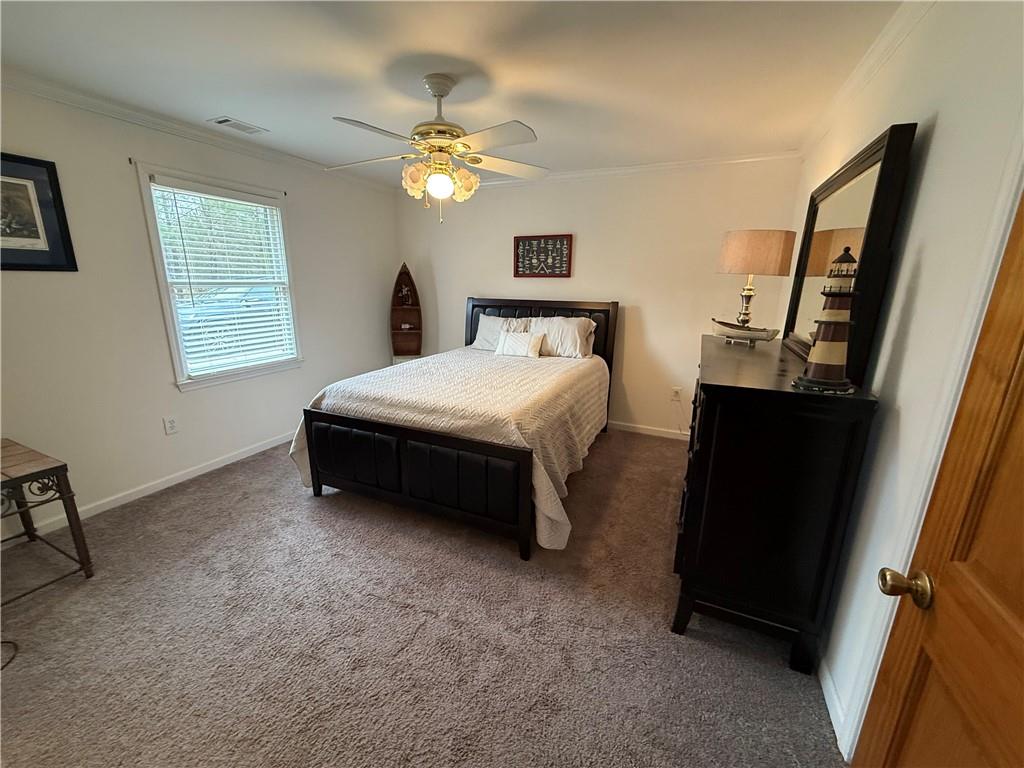 3280 Stanton Road Southeast Conyers, GA 30094 - Photo 35 of 49 a spacious bedroom with a bed and a chandelier