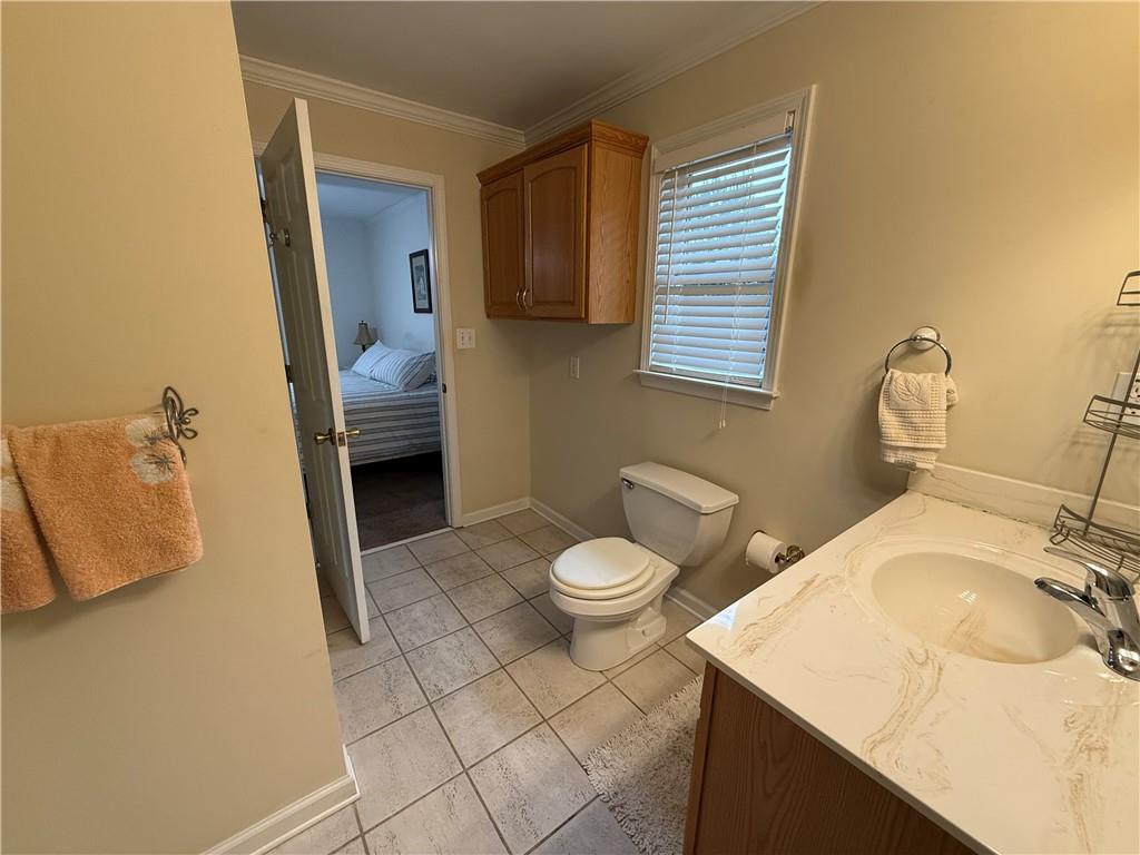3280 Stanton Road Southeast Conyers, GA 30094 - Photo 38 of 49 a bathroom with a sink a toilet and a mirror