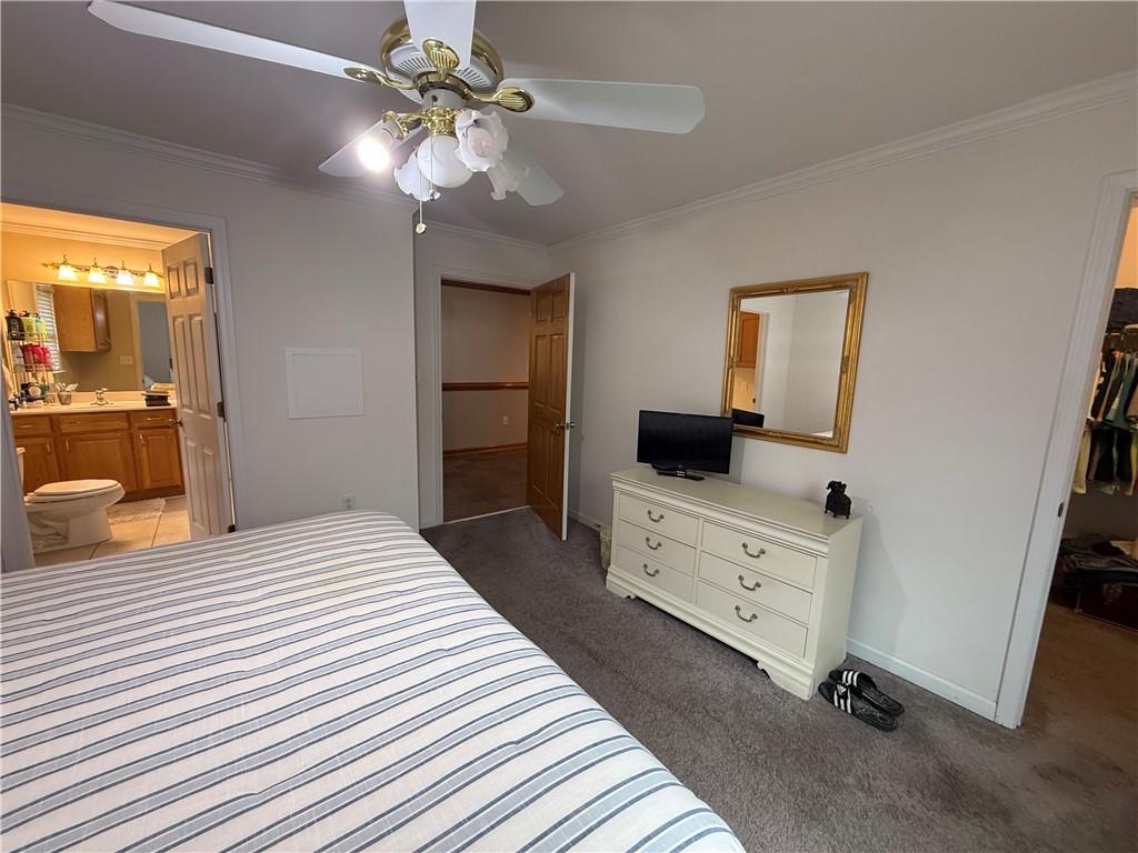 3280 Stanton Road Southeast Conyers, GA 30094 - Photo 42 of 49 a bedroom with a bed and a chandelier