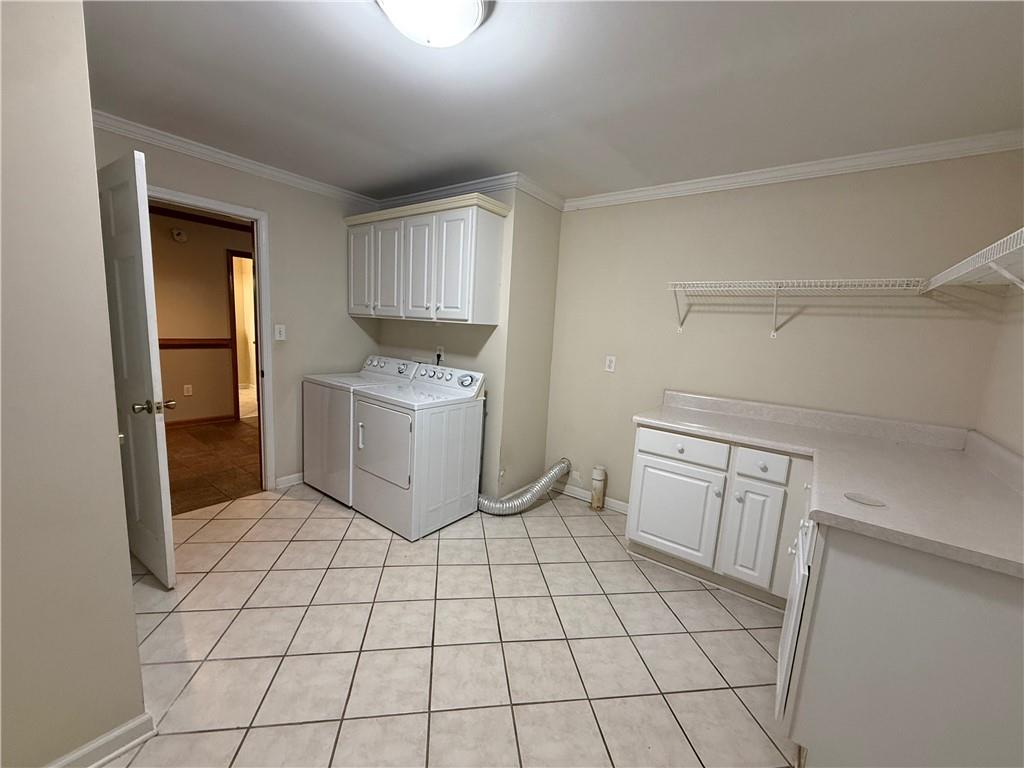 3280 Stanton Road Southeast Conyers, GA 30094 - Photo 45 of 49 a room with a washing machine and cabinets