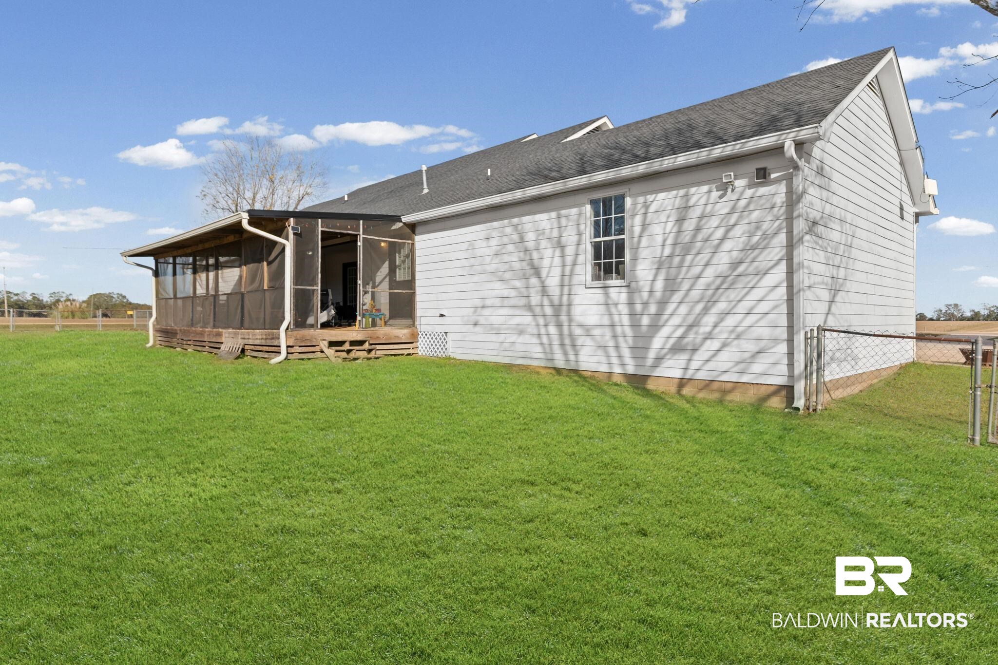 3842 Experiment Farm Road Monroeville, AL 36460 - Photo 12 of 59 Rear view of property featuring a sunroom, a wooden deck, and roof with shingles