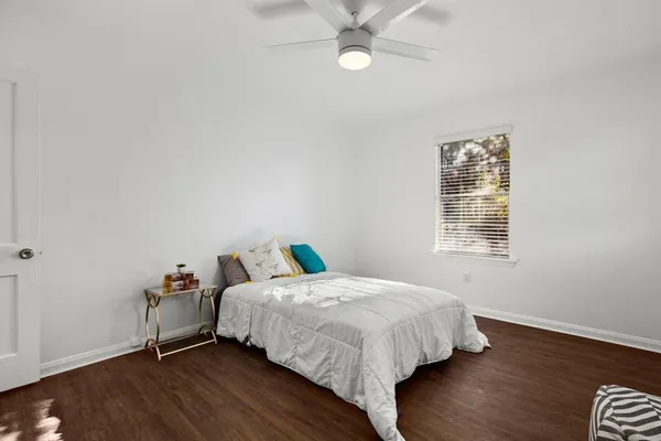 a bedroom with a bed and a window