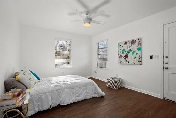 a bedroom with a bed and a painting on the wall