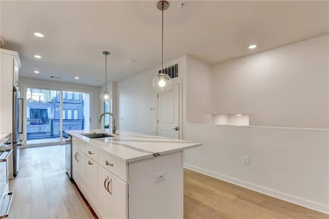 a view of a kitchen island a sink and dishwasher