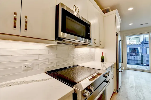a kitchen with a sink and chandelier