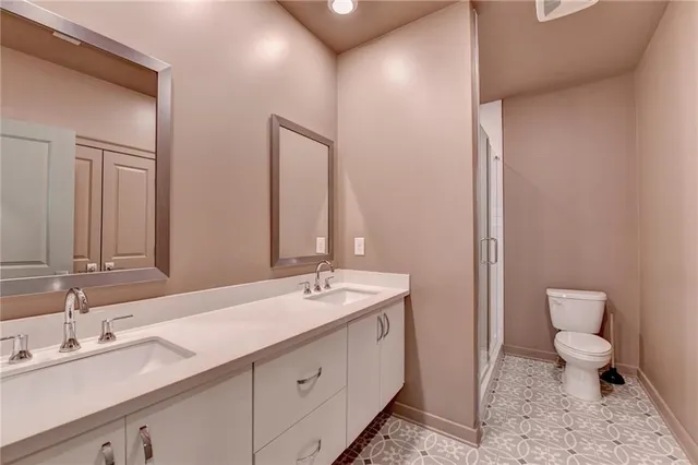 a view of an empty room with closet and a window