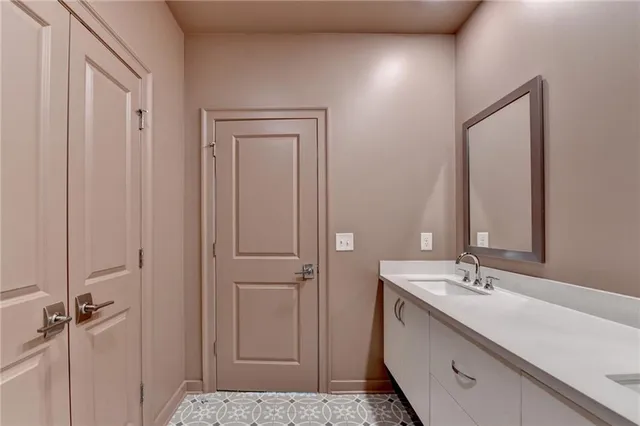 a bathroom with a bathtub shower sink vanity mirror and toilet