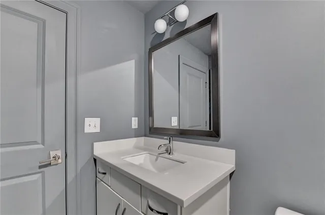 a living room with furniture and painting on the wall