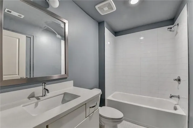 a living room with stainless steel appliances kitchen island granite countertop a dining table chairs and a kitchen view