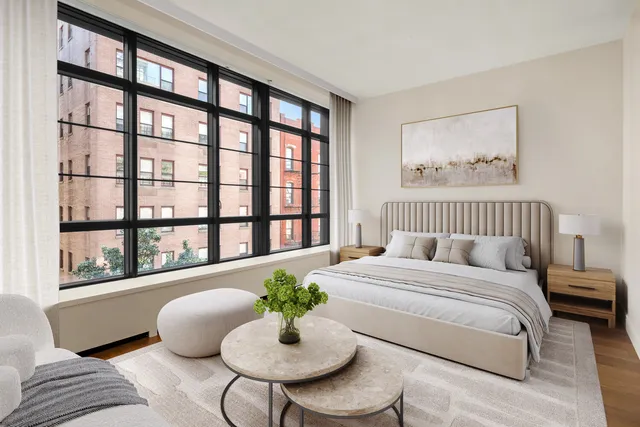 a bedroom with a large bed and a window