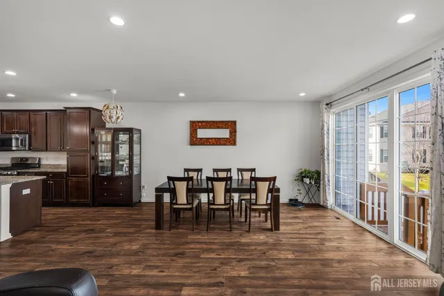 a view of dining room with furniture and wooden floor