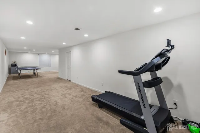 a room with wooden floor pool table and stairs