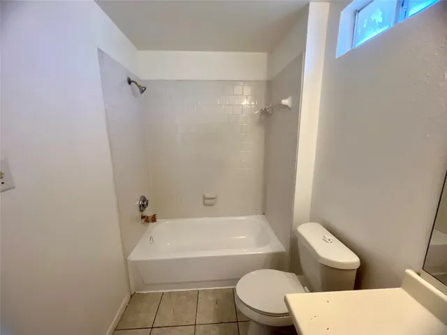 a bathroom with a toilet and a bathtub