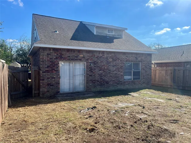 a view of a wooden door and a yard