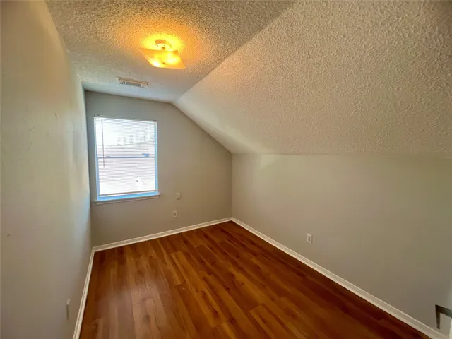 a view of room with window and wooden floor