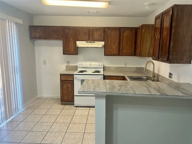 a kitchen with a sink stove and cabinets