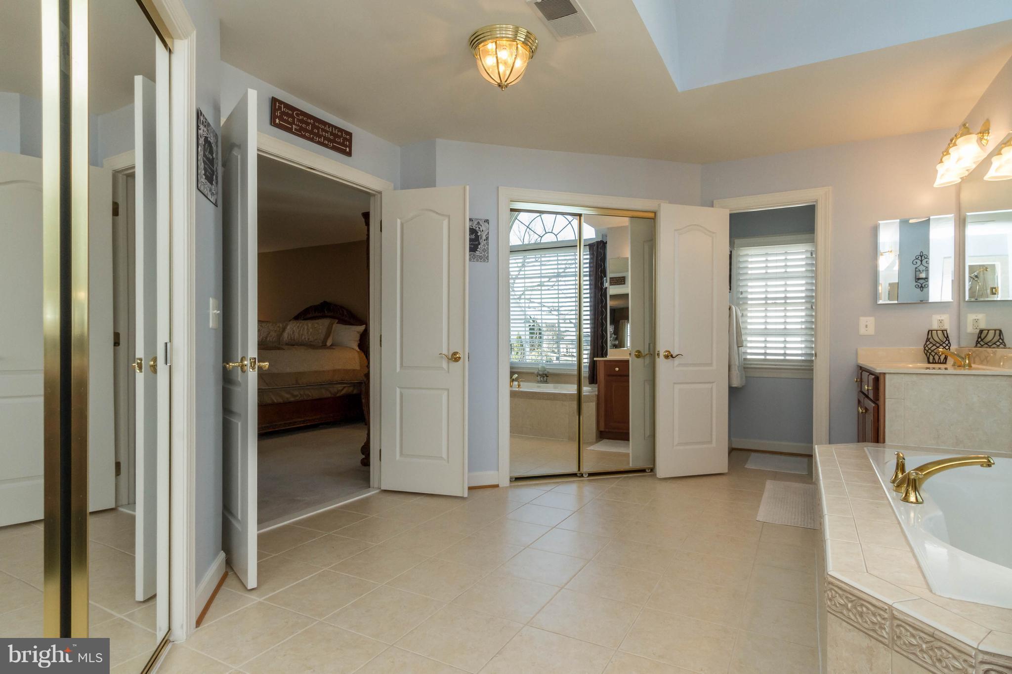 8247 Roxborough Loop Gainesville, VA 20155 - Photo 19 of 30 Dual Walk-in Closets with Sliding Mirrored Doors