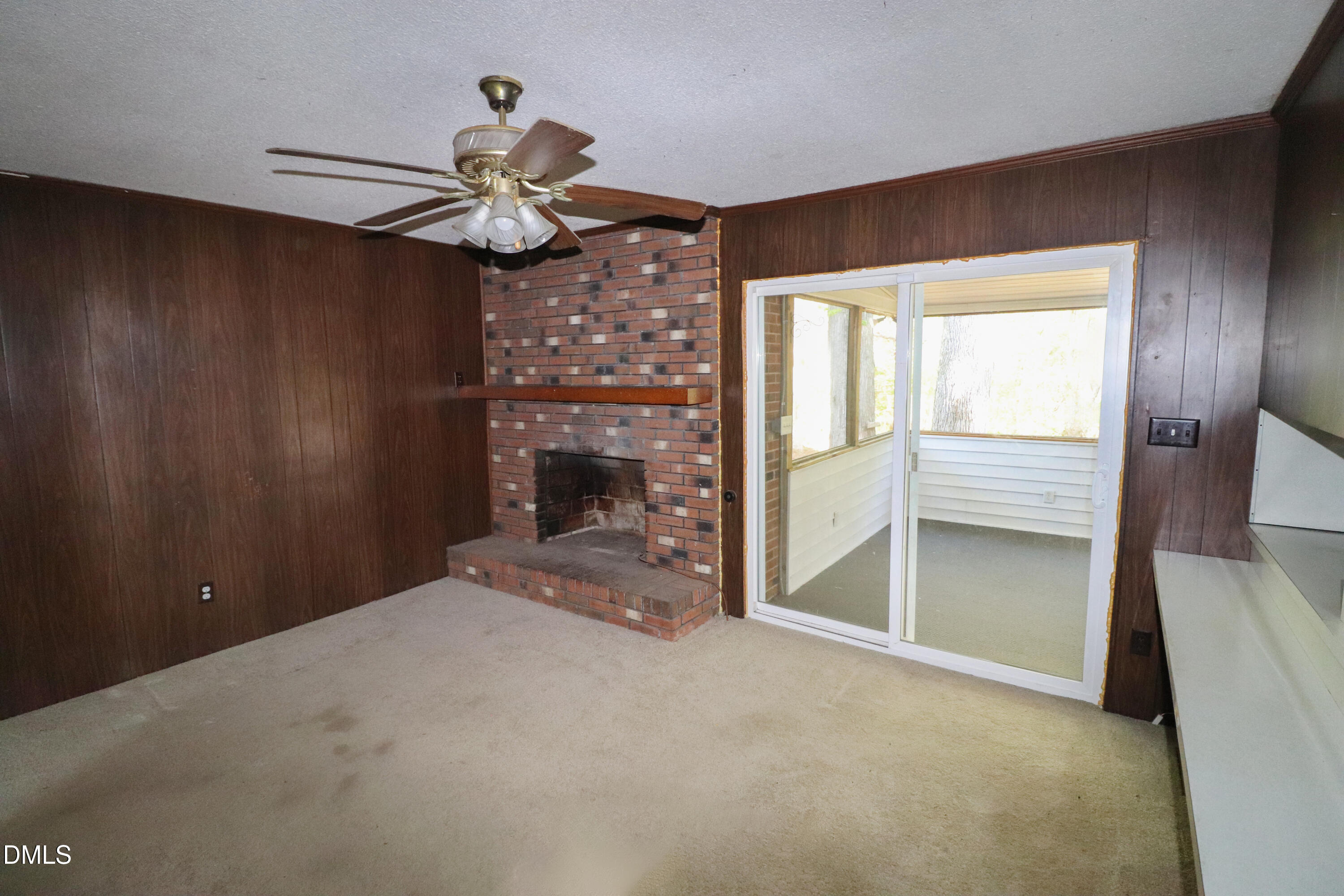 163 Walton Road Youngsville, NC 27596 - Photo 14 of 45 a view of an empty room with a fireplace and a window