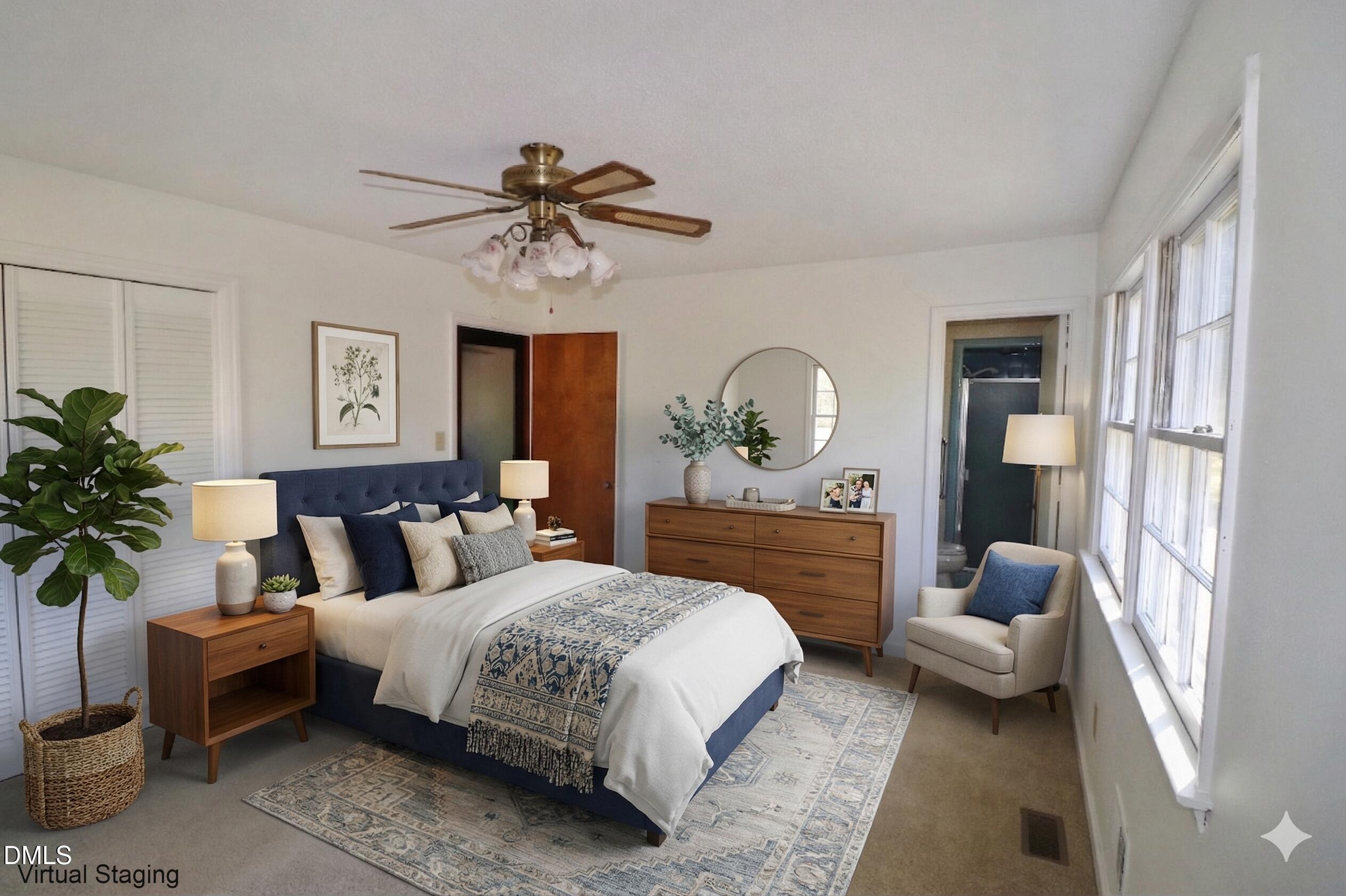 163 Walton Road Youngsville, NC 27596 - Photo 16 of 45 a bedroom with a large bed and a chandelier