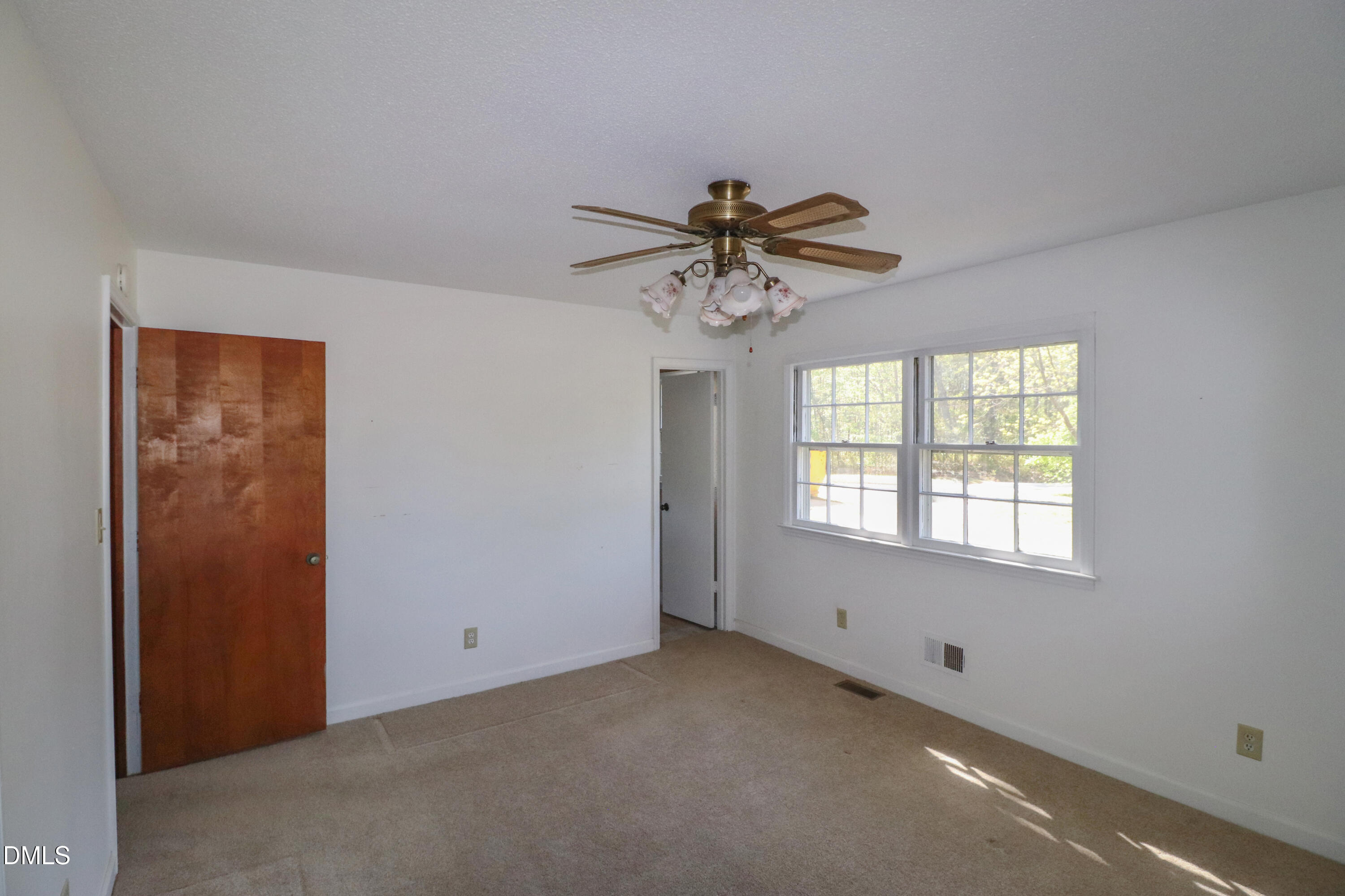 163 Walton Road Youngsville, NC 27596 - Photo 20 of 45 an empty room with a window and a fan