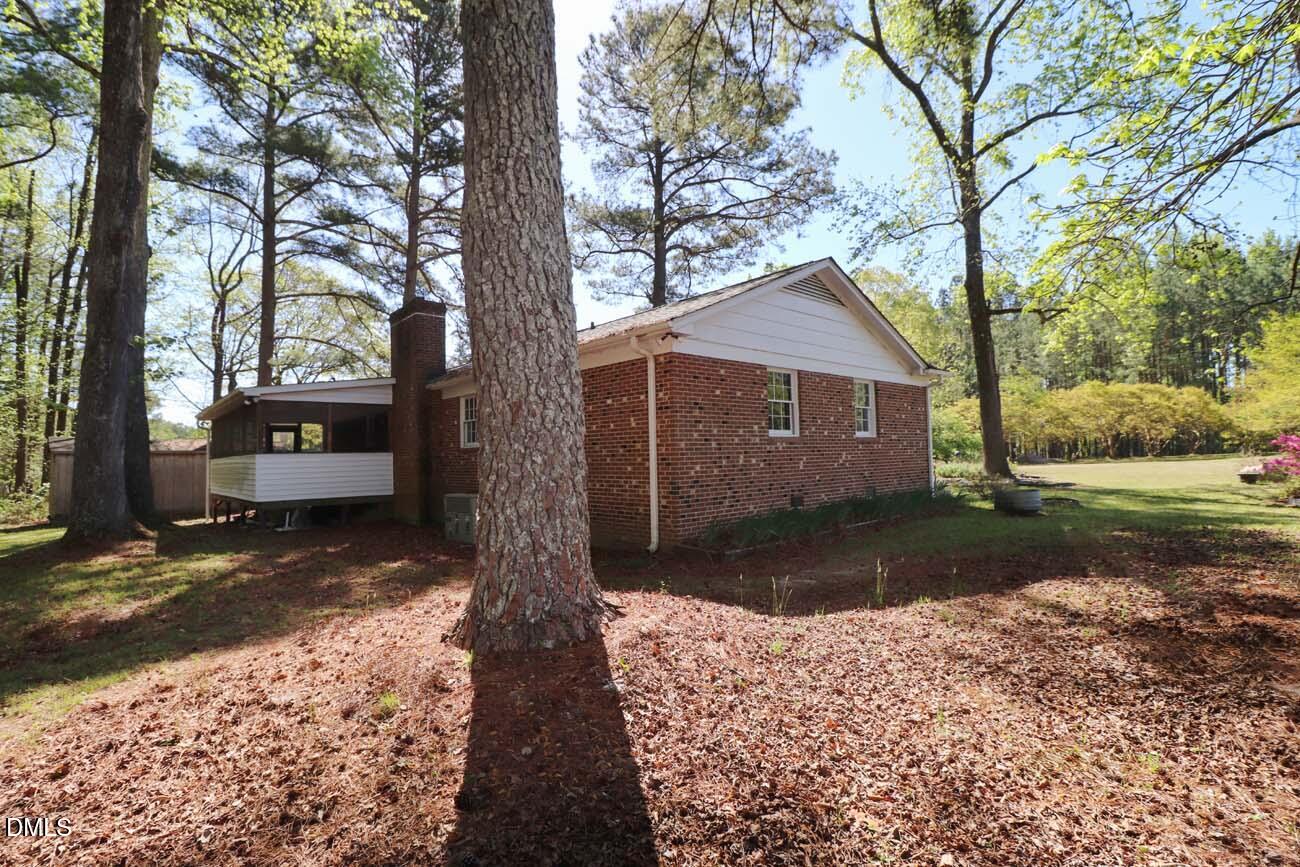 163 Walton Road Youngsville, NC 27596 - Photo 43 of 45 a front view of a house with a yard and garage