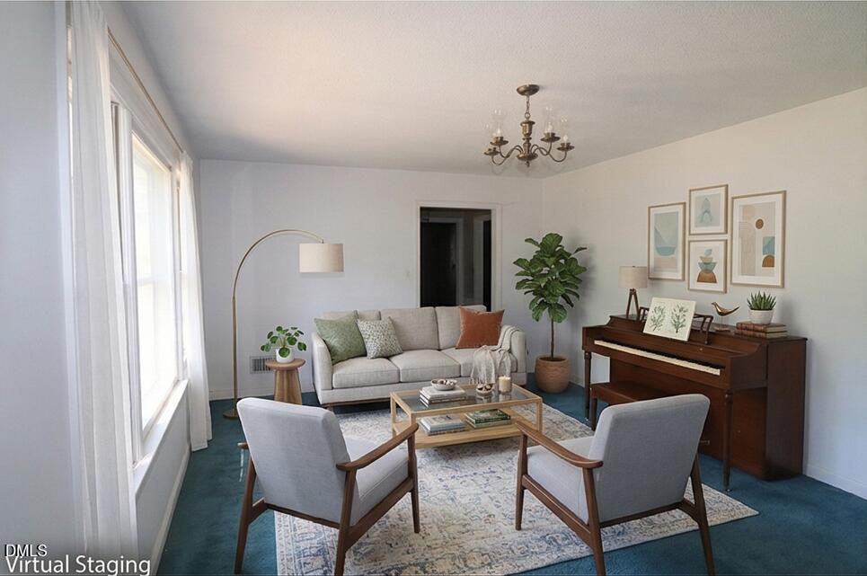 163 Walton Road Youngsville, NC 27596 - Photo 5 of 45 a living room with furniture potted plant and a window