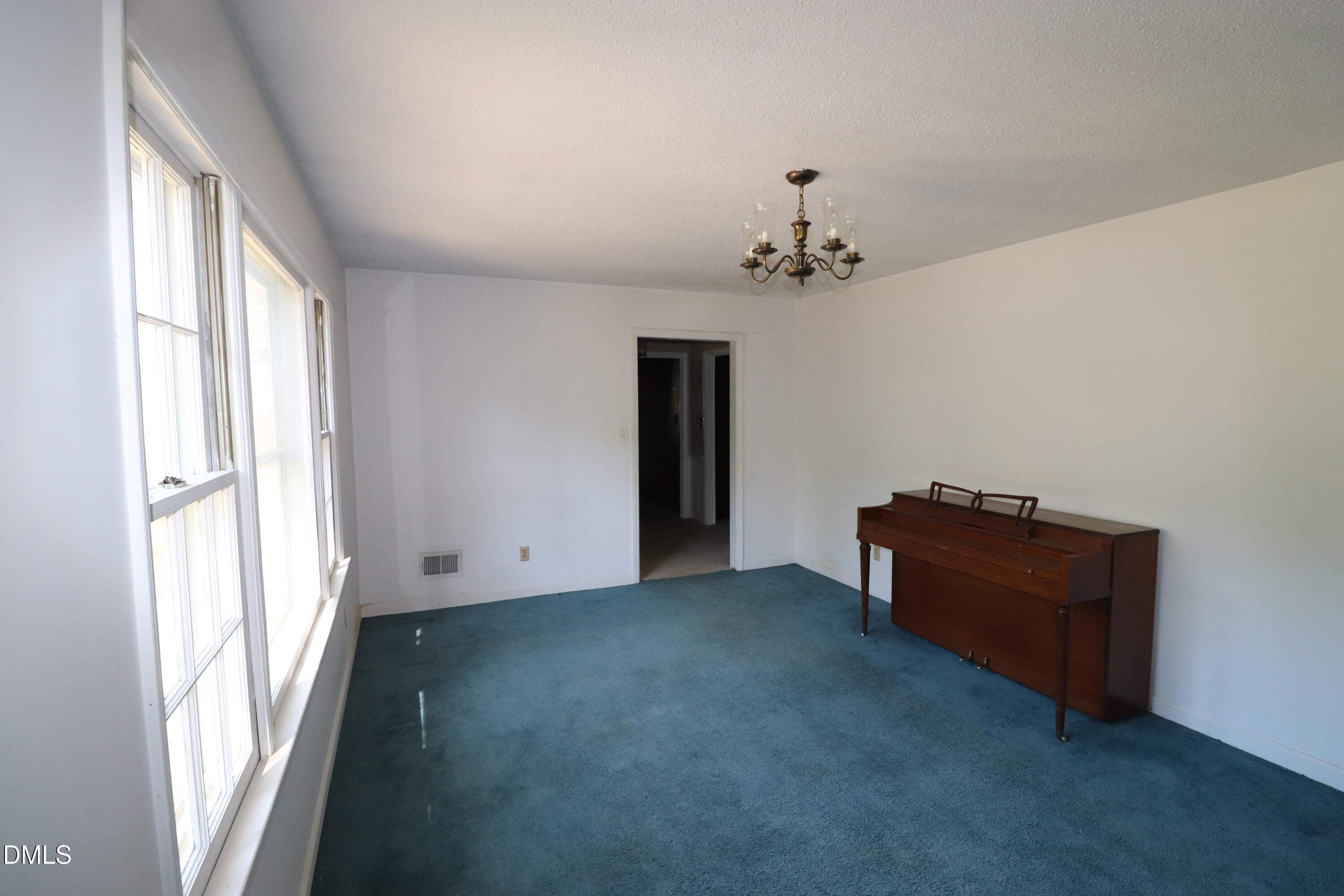 163 Walton Road Youngsville, NC 27596 - Photo 6 of 45 a view of an empty room with a window