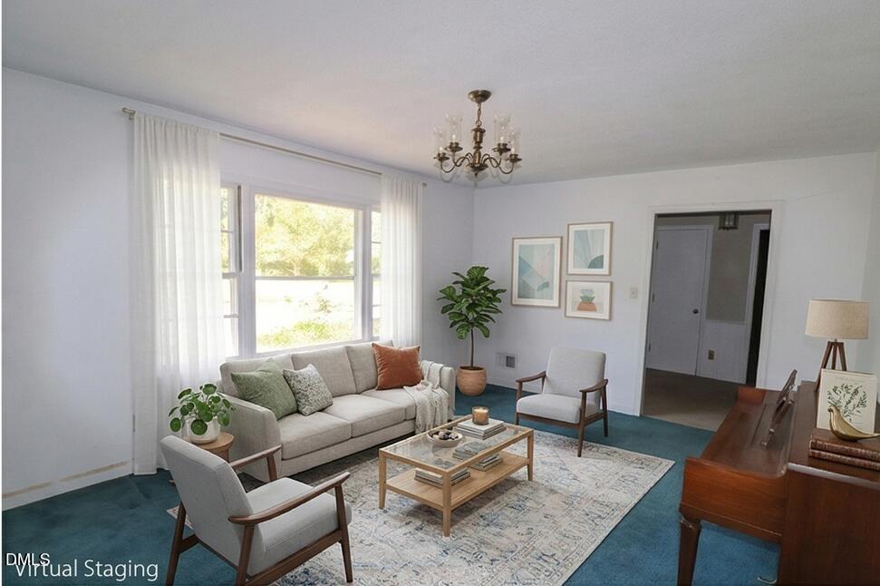 163 Walton Road Youngsville, NC 27596 - Photo 7 of 45 a living room with furniture a chandelier and a window