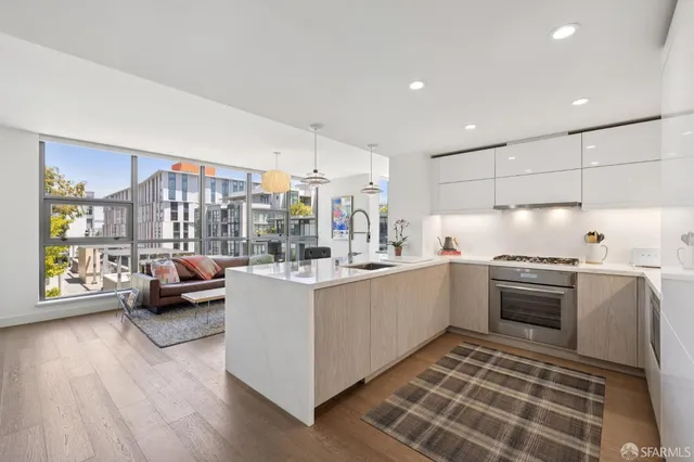 a kitchen with kitchen island wooden cabinets and stainless steel appliances