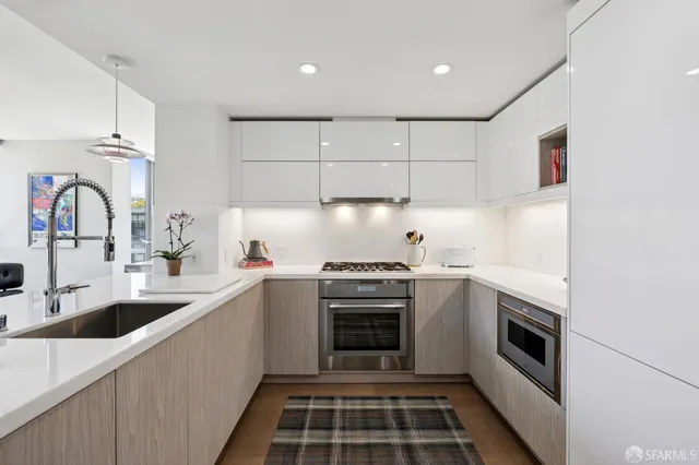 a kitchen with a sink stove and oven