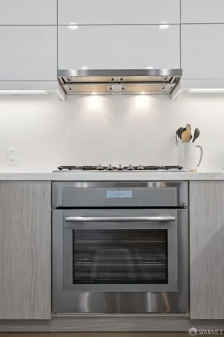 a stove top oven sitting inside of a kitchen
