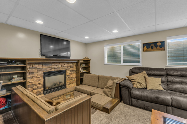 10705 Green Ridge Drive Sandy, UT 84070 - Photo 30 of 55 Living room featuring a paneled ceiling, a fireplace, and carpet floors