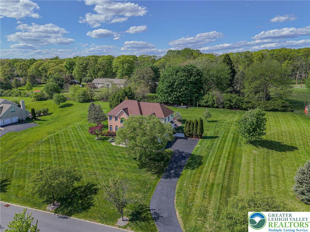 6551 Overlook Road Orefield, PA 18069 - Photo 1 of 82 a view of a garden with a building in the background