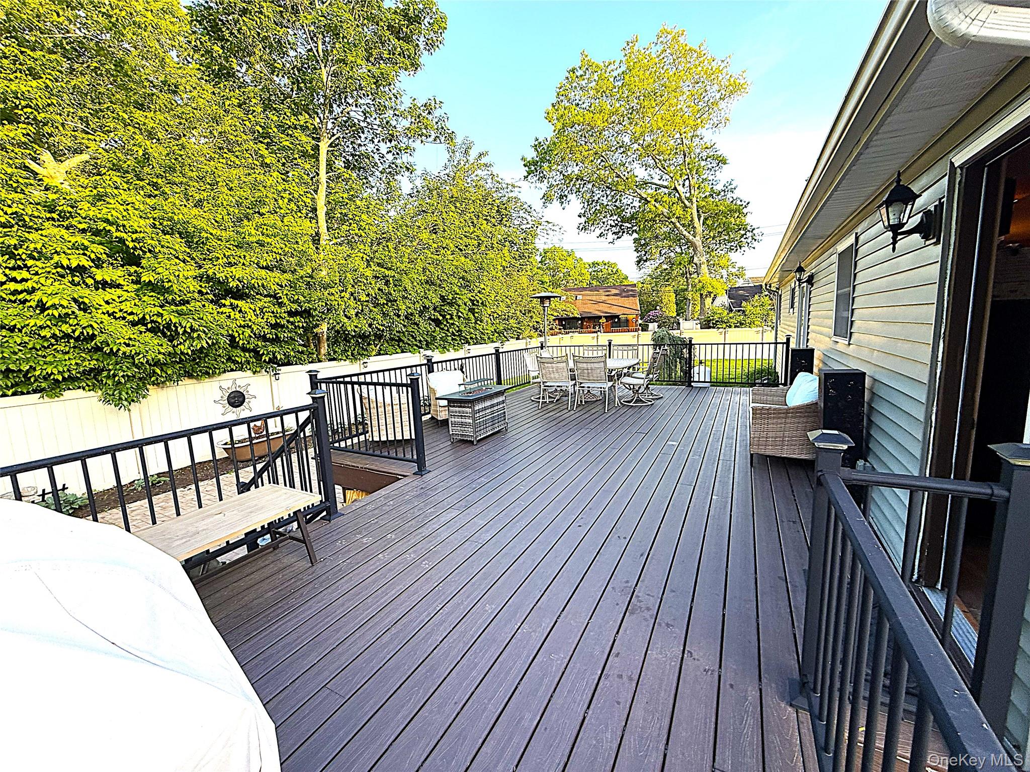 1 Heston Road Shirley, NY 11967 - Photo 24 of 32 Expansive multi-level composite decking featuring black metal railings, direct access to the interior, and a fenced perimeter