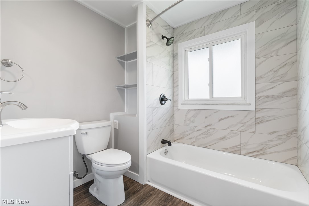 10876 West Sprague Road Cleveland, OH 44130 - Photo 6 of 31 Full bathroom featuring hardwood / wood-style floors, vanity, toilet, and tiled shower / bath combo